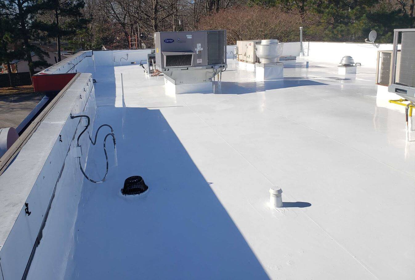 A commercial roof under a new white reflective coating