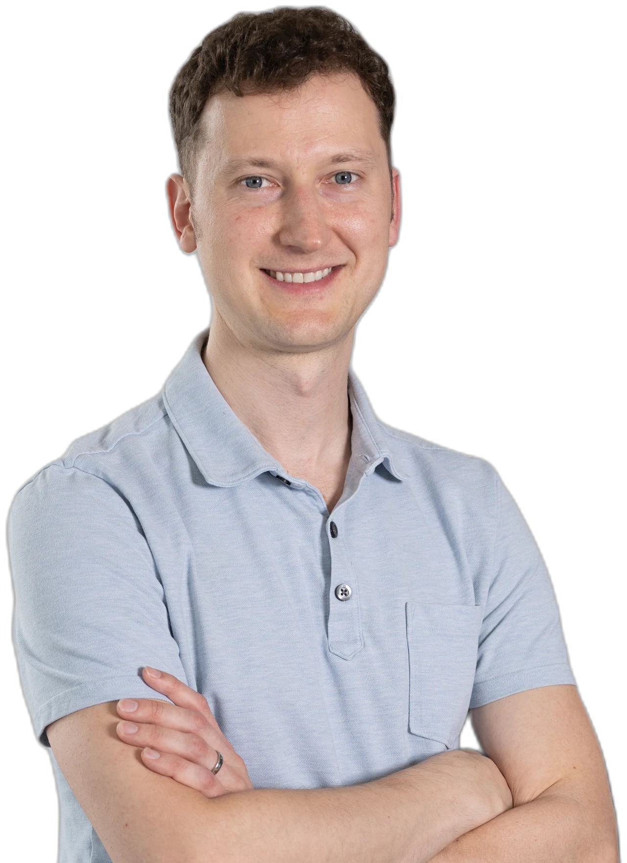 A smiling RoofingSource teammate in a light blue polo, arms folded
