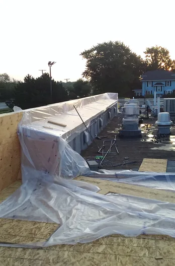 A commercial re-roof under way, the deck opened up and the parapet framed out