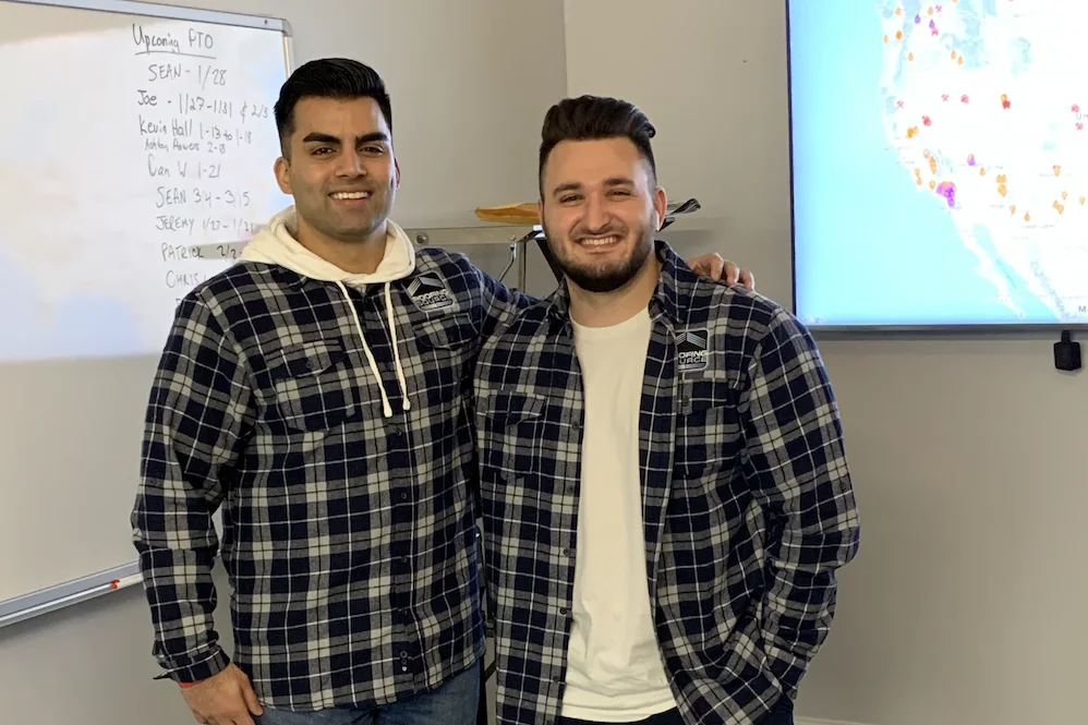 Two RoofingSource teammates at headquarters during a training session