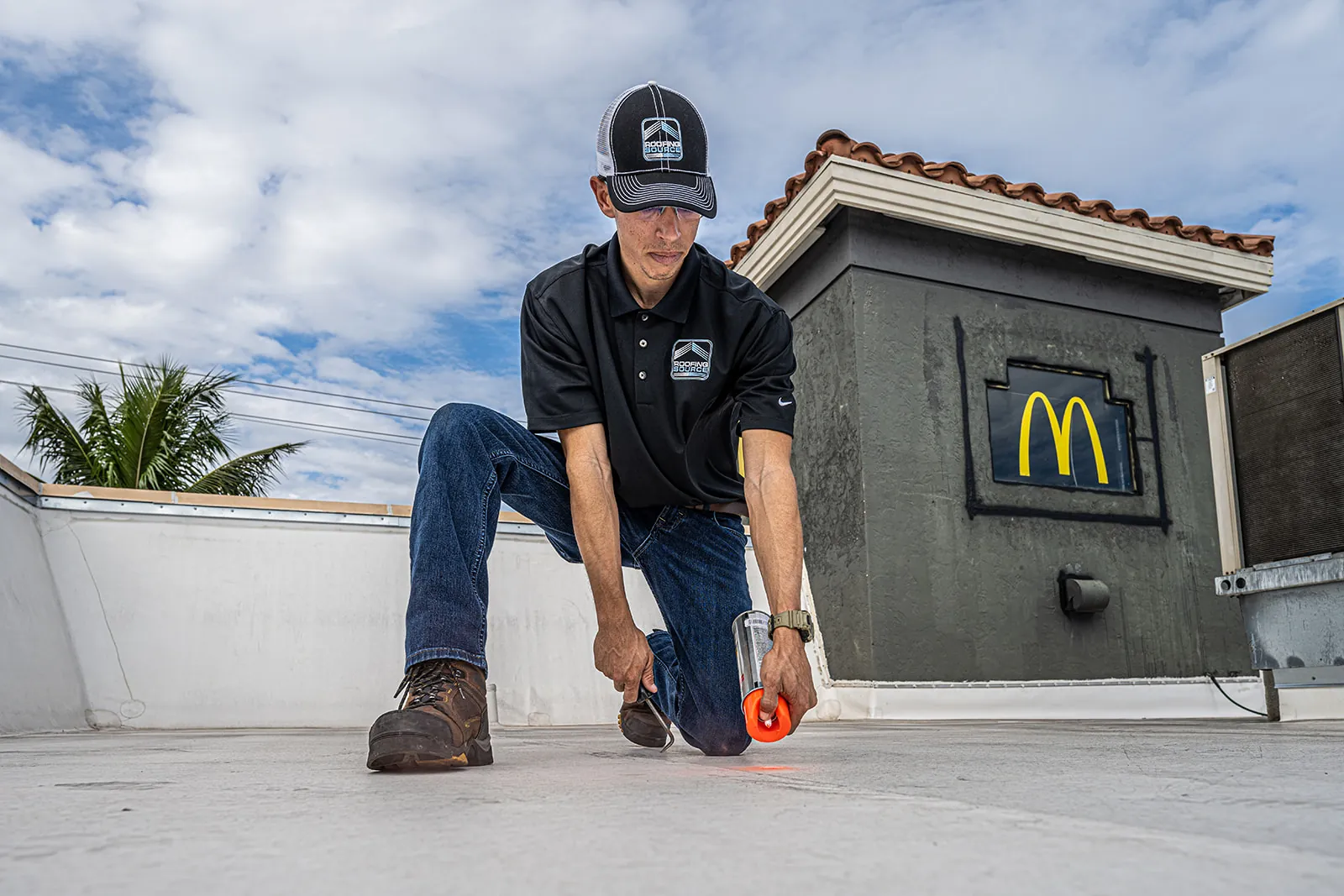 A RoofingSource Field Advisor marking a defect during a routine service visit